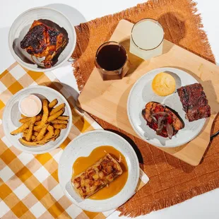 a plate of ribs, french fries, and a glass of beer