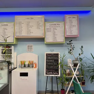 the menus on the wall of a coffee shop