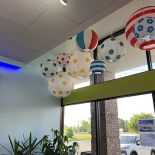 a variety of paper lanterns hanging from the ceiling