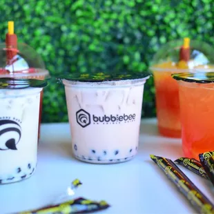 three different drinks in plastic cups