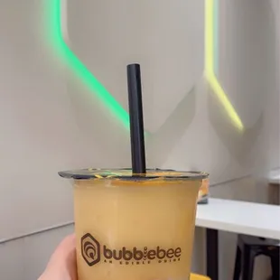 a hand holding a cup of bubble tea