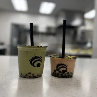 two cups of bubble tea on a counter