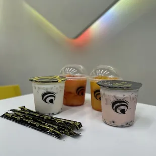 three cups of yogurt and two strawberries