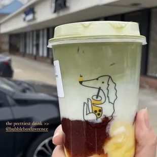 a hand holding a cup of coffee