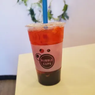 Strawberry green tea with boba.