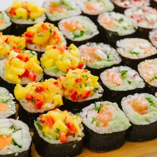 a variety of sushi on a cutting board