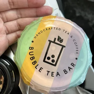 a hand holding a cup of coffee