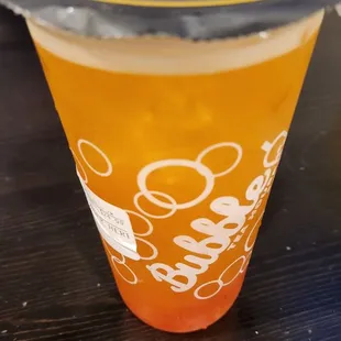 Passion fruit green tea with strawberry popping boba