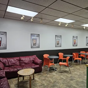 a coffee shop with red leather furniture