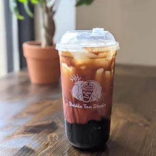 a cup of iced coffee on a table