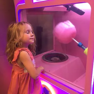 She is embracing the making of the cotton candy heart.