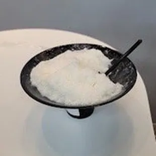 a bowl of sugar and a spoon