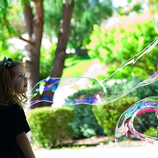 girl playing with bubbles