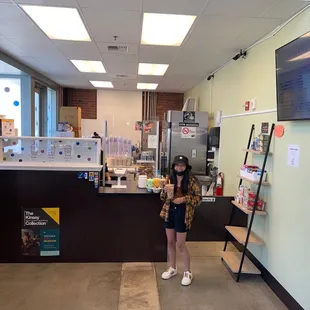 a woman standing in a coffee shop