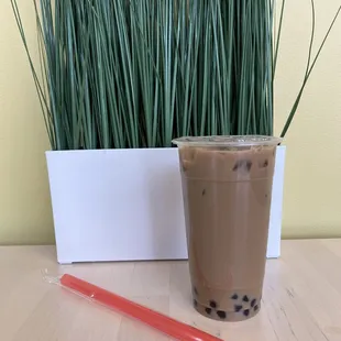 a cup of bubble tea and a straw