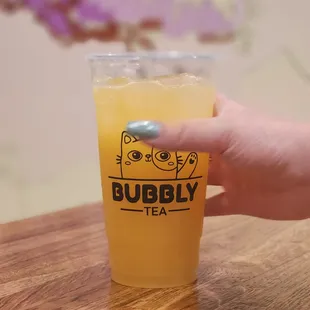 a hand holding a cup of tea