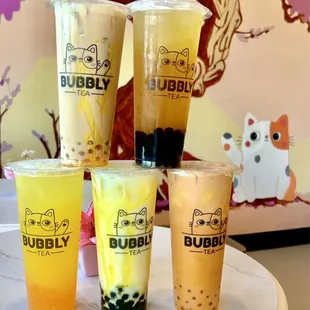 four cups of bubble tea on a table