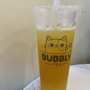 Mango fruit tea with lychee popping boba