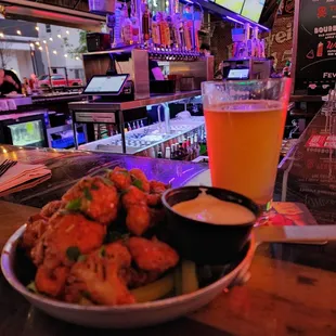 a plate of shrimp and a glass of beer