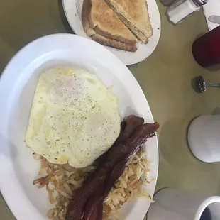 Bacon, eggs hash browns and toast