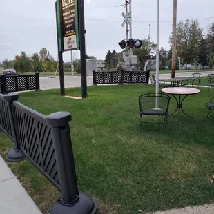 a table and benches in a grassy area