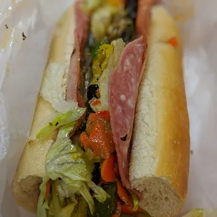 a sub sandwich with meat and vegetables