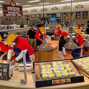 Brisket and pulled bbq pork being put into sandwiches hot fresh