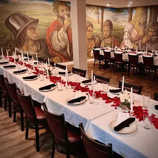 a long dining table with candles and flowers