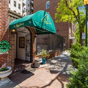 a brick building with a green awning