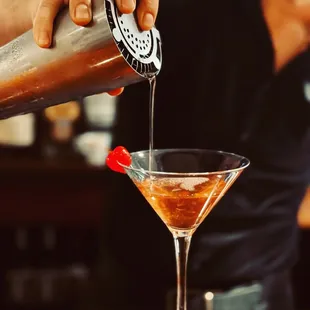 a bartender pouring a drink