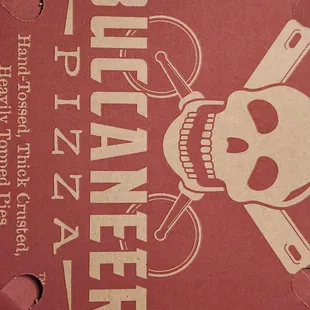 a pizza box with a skull and knife on it