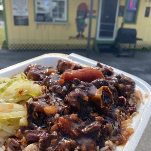 Oxtail Dinner served with rice and peas side of cabbage