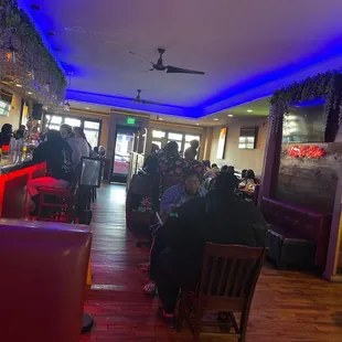 people sitting at tables in a restaurant