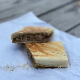 a half eaten sandwich on a napkin