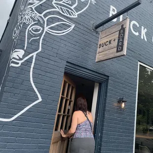 a woman opening a door