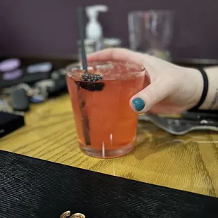 a person holding a drink
