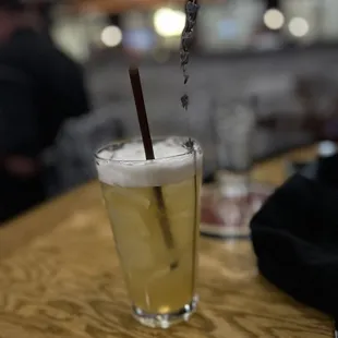 a glass of beer on a bar