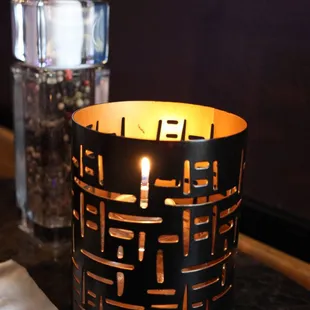 a lit candle on a table