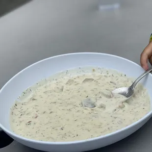 a child eating a bowl of soup