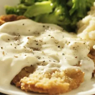 chicken fried with gravy and mashed potatoes