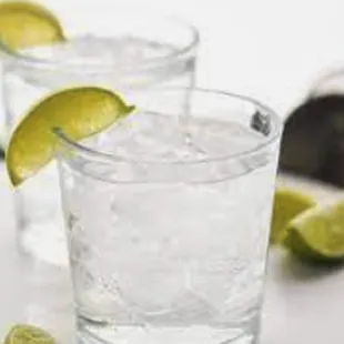 two glasses of water with lime wedges