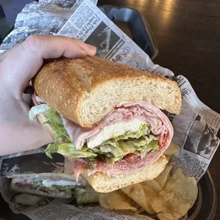 a hand holding a sandwich