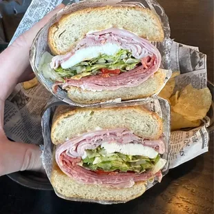 a hand holding a sandwich