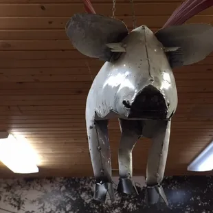 a cow hanging from the ceiling