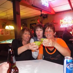 three people enjoying a drink