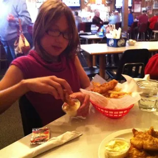 a girl eating a sandwich