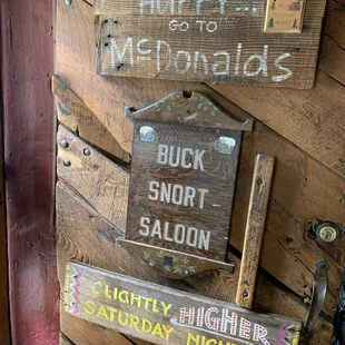 signs on a wooden wall