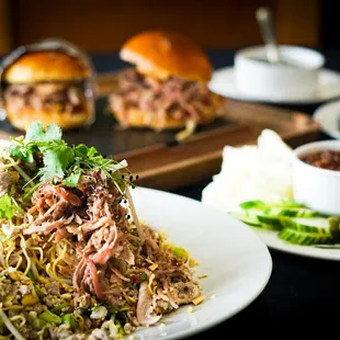 Buck Tui Noodles with Pulled Heavenly Pork in the foreground, The X Man Sandwiches in the background.
