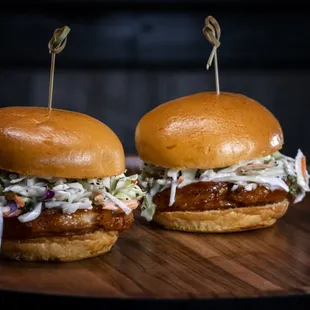 two sandwiches on a wooden board