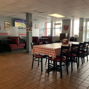 a dining area with tables and chairs